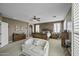 Spacious main bedroom with ceiling fan, sitting area, and comfortable layout at 43650 W Snow Dr, Maricopa, AZ 85138