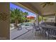 Inviting patio with stylish seating, an umbrella, a hot tub, and a view of the pool at 43650 W Snow Dr, Maricopa, AZ 85138