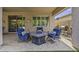 Comfortable seating arrangement with a fire pit, outdoor grill, and lush greenery for relaxation at 43650 W Snow Dr, Maricopa, AZ 85138