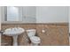 Cozy bathroom with pedestal sink, white fixtures, and decorative wainscotting at 4522 S Wildflower Pl, Chandler, AZ 85248