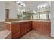 Bathroom vanity features double sinks, tile countertops, and wood cabinets under large mirrors with lighting at 4522 S Wildflower Pl, Chandler, AZ 85248