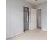 Carpeted bedroom featuring an open closet with shelving, light-colored walls, and neutral carpet at 4522 S Wildflower Pl, Chandler, AZ 85248