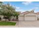 Inviting single-story home featuring a two-car garage, landscaped front yard, and a classic tile roof at 4522 S Wildflower Pl, Chandler, AZ 85248