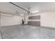 Spacious garage with gray cabinets, a door, and sealed concrete floors for functionality and convenience at 4522 S Wildflower Pl, Chandler, AZ 85248