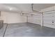 Spacious garage with a door, an automatic garage door opener, and sealed concrete floors for functionality and convenience at 4522 S Wildflower Pl, Chandler, AZ 85248