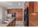 Bright kitchen showcasing dark wood cabinetry, granite counters, and modern appliances at 4522 S Wildflower Pl, Chandler, AZ 85248