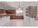 Eat-in kitchen featuring granite countertops, tile flooring, and adjacent living space at 4522 S Wildflower Pl, Chandler, AZ 85248