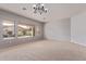 Inviting living room with neutral carpet, large windows overlooking the backyard, and a serene atmosphere at 4522 S Wildflower Pl, Chandler, AZ 85248