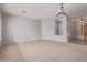 Bright living room with neutral carpet, elegant chandelier, and open layout leading to other rooms at 4522 S Wildflower Pl, Chandler, AZ 85248