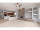 Open-concept living room seamlessly connected to the kitchen area, featuring a cozy fireplace at 4522 S Wildflower Pl, Chandler, AZ 85248