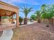 Beautiful backyard showcasing mature palm trees, an outdoor kitchen, and a swimming pool at 4582 S Wildflower Pl, Chandler, AZ 85248