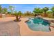 Captivating backyard featuring a stone pool, lush landscaping, and an outdoor grill area at 4582 S Wildflower Pl, Chandler, AZ 85248