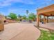 Expansive backyard featuring a stone pool, a built-in grill, and a covered patio area at 4582 S Wildflower Pl, Chandler, AZ 85248