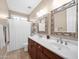 Bathroom featuring double sinks, framed mirrors, and a shower/tub combo, all with natural lighting at 4582 S Wildflower Pl, Chandler, AZ 85248