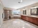 Spacious bathroom featuring a separate shower, tub, and double vanity, with neutral tile and natural light at 4582 S Wildflower Pl, Chandler, AZ 85248