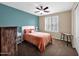 Cozy bedroom with a ceiling fan, plush carpet, and a window with plantation shutters at 4582 S Wildflower Pl, Chandler, AZ 85248
