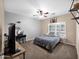 Comfortable bedroom featuring neutral carpet and a ceiling fan, complete with a window at 4582 S Wildflower Pl, Chandler, AZ 85248