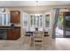 Sunlit dining area with a window-filled breakfast nook, and sliding glass doors for indoor-outdoor living at 4582 S Wildflower Pl, Chandler, AZ 85248