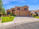 Two-story home with three-car garage, terracotta roof, landscaped yard, and concrete driveway at 4582 S Wildflower Pl, Chandler, AZ 85248