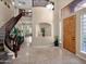 Grand foyer with wood door, travertine floors, staircase, and soaring ceilings at 4582 S Wildflower Pl, Chandler, AZ 85248