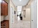 Inviting hallway with travertine flooring and stylish decor, providing a seamless transition throughout the home at 4582 S Wildflower Pl, Chandler, AZ 85248