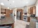 Open kitchen with an island, stainless steel Viking appliances, and seamlessly connected dining and living areas at 4582 S Wildflower Pl, Chandler, AZ 85248