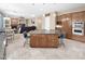 Open kitchen with an island, stainless steel appliances, and seamlessly connected dining and living areas at 4582 S Wildflower Pl, Chandler, AZ 85248