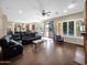 Open living area with wood floors, large windows, and a fireplace, offering plenty of natural light at 4582 S Wildflower Pl, Chandler, AZ 85248