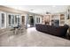 Open-concept living room and dining area with fireplace and seamless access to the outdoors through glass doors at 4582 S Wildflower Pl, Chandler, AZ 85248