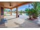 Spacious covered patio leading to a landscaped backyard with a pool and outdoor kitchen at 4582 S Wildflower Pl, Chandler, AZ 85248