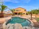 Backyard pool showcasing desert landscaping, mature palm trees, and comfortable lounging areas at 4582 S Wildflower Pl, Chandler, AZ 85248