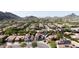 An aerial view of a suburban community nestled near picturesque mountains, featuring neatly arranged homes and lush trees at 5222 W El Cortez Trl, Phoenix, AZ 85083