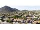 An aerial view showcasing a well-maintained residential area with red tile roofs, green trees, and beautiful desert landscaping at 5222 W El Cortez Trl, Phoenix, AZ 85083