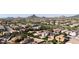 Expansive aerial view of a well-planned community featuring tidy homes, desert landscaping, and neighborhood streets at 5222 W El Cortez Trl, Phoenix, AZ 85083