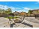 Inviting backyard featuring a fire pit area with chairs, string lights and synthetic lawn at 5222 W El Cortez Trl, Phoenix, AZ 85083