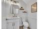 Powder room with white vanity, modern mirror, and wainscoting at 5222 W El Cortez Trl, Phoenix, AZ 85083