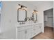 Bright bathroom featuring dual sinks, decorative mirrors, and stylish fixtures for a modern aesthetic at 5222 W El Cortez Trl, Phoenix, AZ 85083