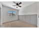 Cozy bedroom with wainscoting, a ceiling fan, and a window, offering a comfortable and stylish space at 5222 W El Cortez Trl, Phoenix, AZ 85083