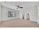 Spacious bedroom with a ceiling fan and a large window, connected to an ensuite bathroom and walk-in closet at 5222 W El Cortez Trl, Phoenix, AZ 85083