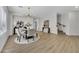 Open-concept dining area featuring wood floors, a modern chandelier, and stylish decor at 5222 W El Cortez Trl, Phoenix, AZ 85083