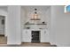 A stylish dry bar with white cabinets, shelves, a beverage fridge, and herringbone backsplash at 5222 W El Cortez Trl, Phoenix, AZ 85083