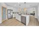 Open-concept kitchen with an island, modern appliances, and seamless flow into the living area at 5222 W El Cortez Trl, Phoenix, AZ 85083