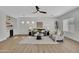 Bright living room featuring a ceiling fan, modern furniture, and a stylish dry bar area at 5222 W El Cortez Trl, Phoenix, AZ 85083