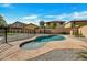 Backyard oasis featuring a sparkling pool surrounded by lush landscaping and ample space for relaxation at 5222 W El Cortez Trl, Phoenix, AZ 85083