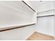 Well-organized walk-in closet with ample shelving and wooden rods for hanging clothes at 5222 W El Cortez Trl, Phoenix, AZ 85083