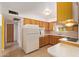 Functional kitchen with wooden cabinets, tile countertops, and essential appliances at 5445 E Dallas St, Mesa, AZ 85205