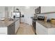 Bright kitchen with white cabinets, stainless steel appliances, and granite countertops at 582 W Freedom St, Florence, AZ 85132