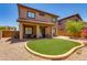 Backyard view of a two story home with a covered patio and well maintained landscaping at 6626 W Laurel Ave, Glendale, AZ 85304