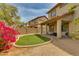 Spacious backyard featuring a covered patio, desert landscaping, and a pop of color with a bougainvillea bush at 6626 W Laurel Ave, Glendale, AZ 85304