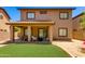 Spacious backyard with a covered patio, artificial grass, and desert style landscaping at 6626 W Laurel Ave, Glendale, AZ 85304